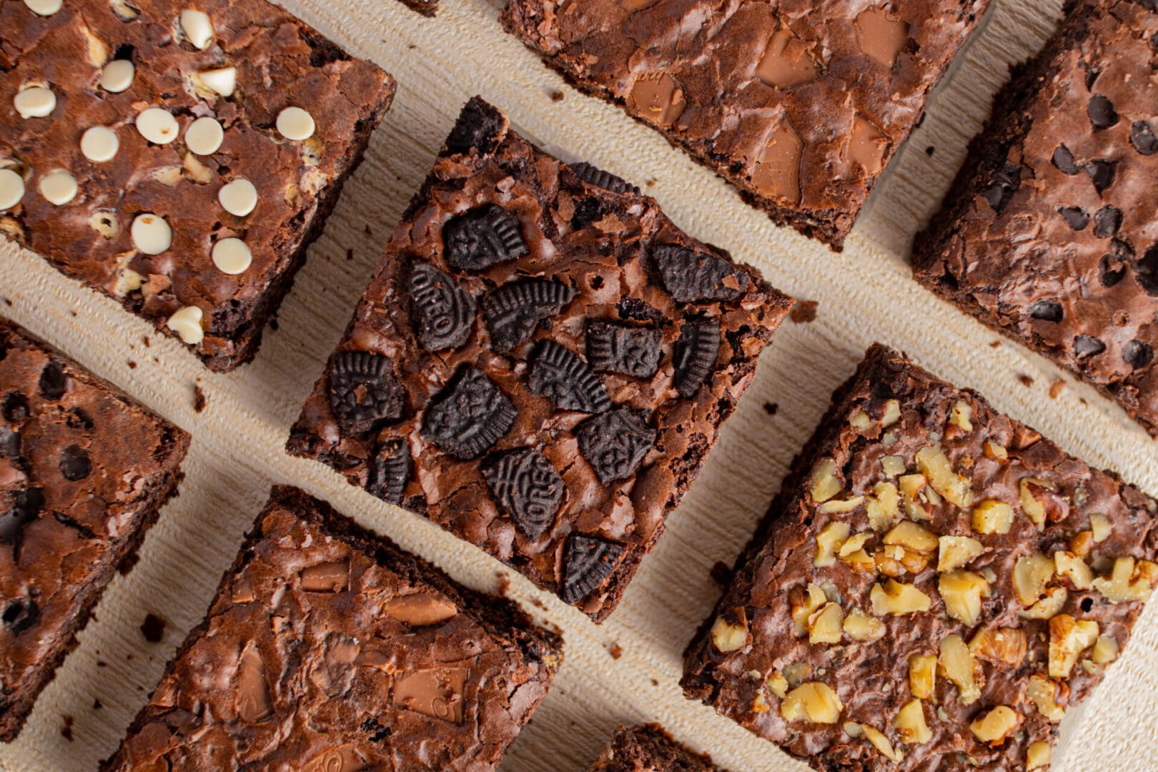 A close up of several different types of brownies.